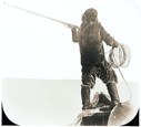 Image of Man with poised harpoon, float, coil